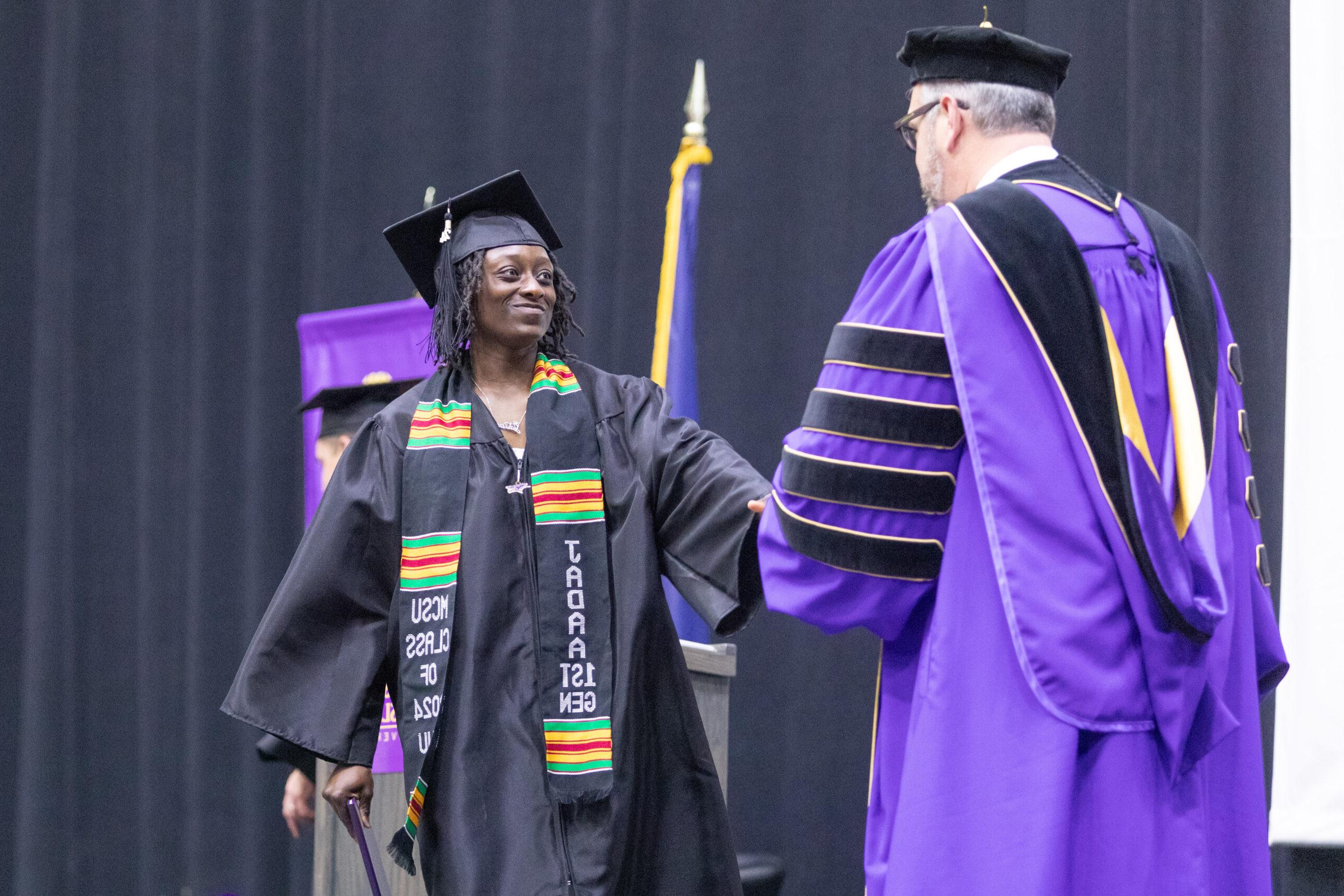 Woman receiving congratulations from President